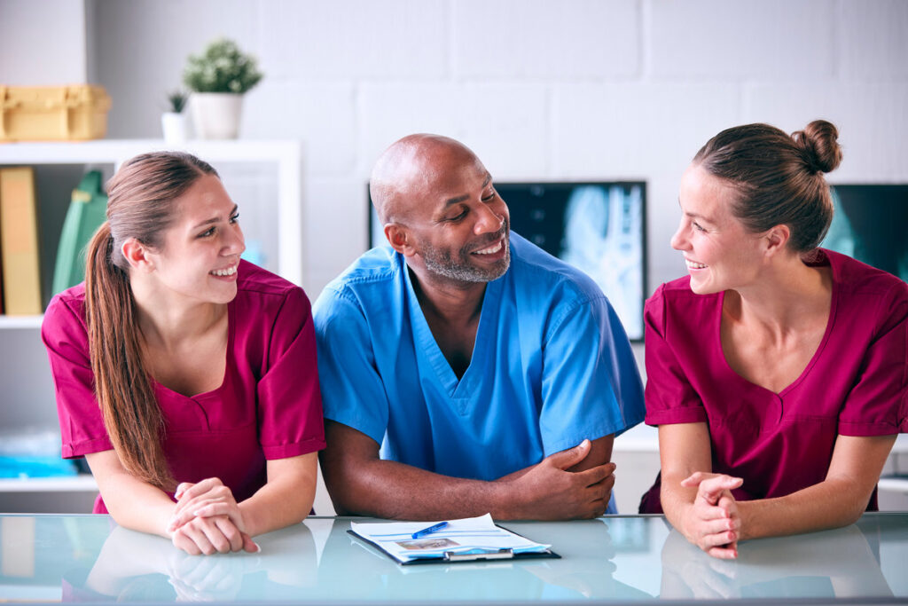 Portrait Of Male And Female Veterinary Team In Surgery