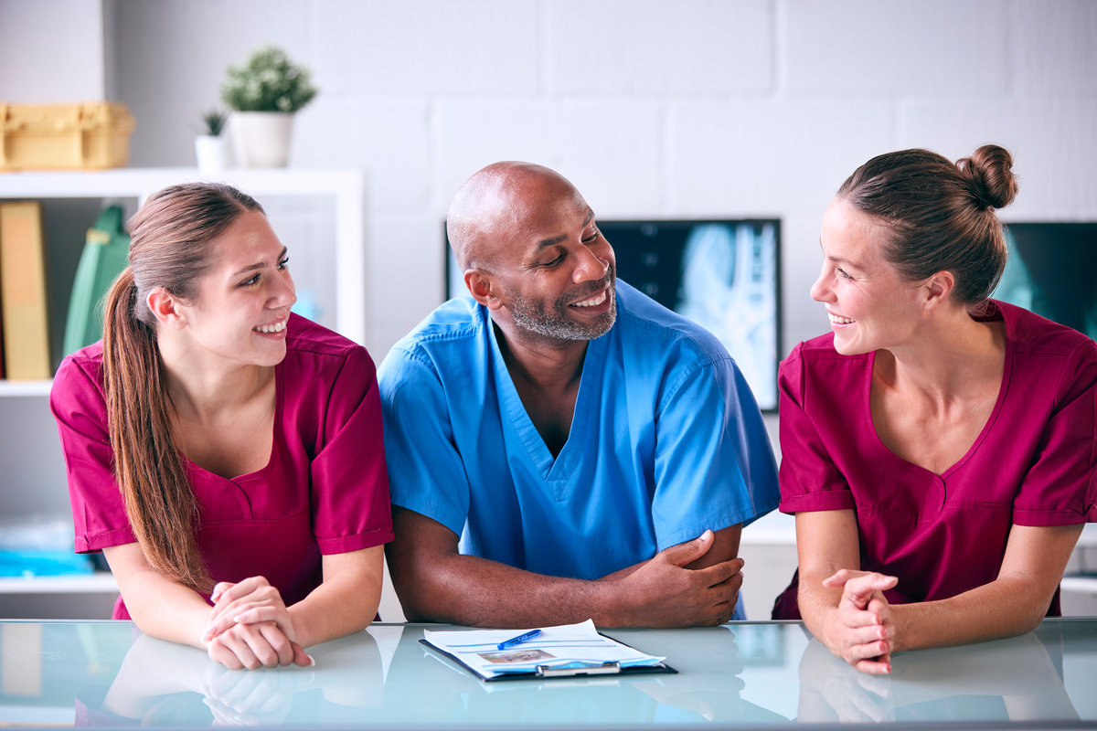 Portrait Of Male And Female Veterinary Team In Surgery